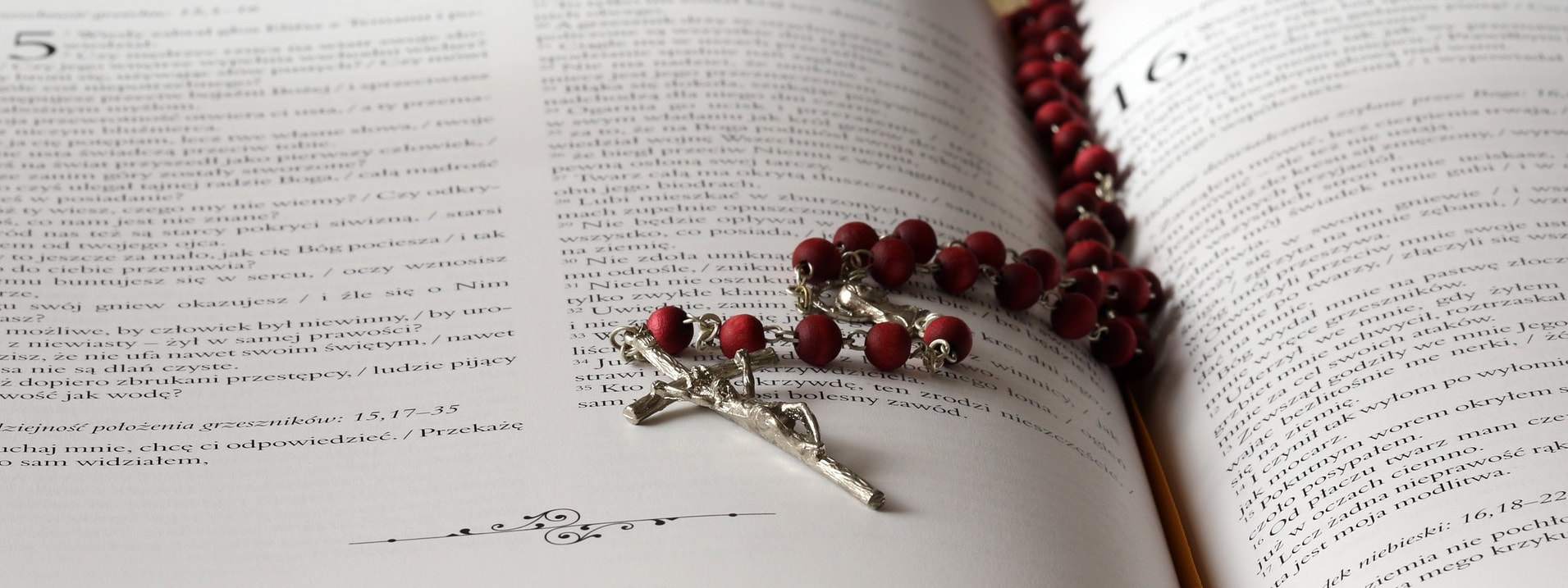 Red rosary on book